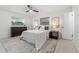 Bright bedroom with a ceiling fan, gray rug, and matching nightstands at 1232 Corbett Ln, Orlando, FL 32806