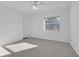 An empty room with white walls, flooring, and natural light from a window at 1232 Corbett Ln, Orlando, FL 32806