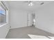 Bright bedroom features neutral walls, speckled floors, a ceiling fan and a window letting in plenty of light at 1232 Corbett Ln, Orlando, FL 32806