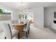 Elegant dining room with modern chandelier and a view into the living space at 1232 Corbett Ln, Orlando, FL 32806
