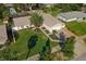 Charming single-story home featuring a well-manicured lawn, lovely landscaping, and an inviting brick-lined driveway at 1232 Corbett Ln, Orlando, FL 32806