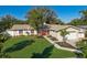 Well-manicured front yard features a lush lawn, mature trees, and meticulous landscaping at 1232 Corbett Ln, Orlando, FL 32806