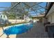Relaxing enclosed in-ground pool with an expansive screened enclosure provides a perfect backyard oasis at 1232 Corbett Ln, Orlando, FL 32806