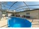 Inviting screened in-ground pool with ladder and patio seating area offers a refreshing escape at 1232 Corbett Ln, Orlando, FL 32806