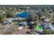 Charming aerial view of a home with a pond in the backyard and a green pool at 1320 Corte Nueva, Winter Springs, FL 32708