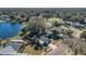 Lovely aerial view of home featuring a lake, fence, and driveway at 1320 Corte Nueva, Winter Springs, FL 32708