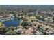 Wonderful aerial view of a neighborhood with a lake, lush trees, and private pools at 1320 Corte Nueva, Winter Springs, FL 32708