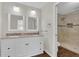 Bathroom featuring a dual sink vanity with granite countertops and a tiled walk-in shower at 1320 Corte Nueva, Winter Springs, FL 32708