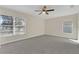 Spacious bedroom with neutral carpet, ceiling fan, and bright natural light from two windows at 1320 Corte Nueva, Winter Springs, FL 32708