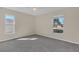 Cozy bedroom featuring neutral carpeting and natural light from two large windows at 1320 Corte Nueva, Winter Springs, FL 32708