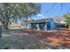 Back of home featuring a screened in patio, yard, and mature trees at 1320 Corte Nueva, Winter Springs, FL 32708