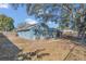 Backyard of a home with siding, a well-maintained lawn and mature trees at 1320 Corte Nueva, Winter Springs, FL 32708