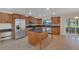 Modern kitchen showcasing a center island, stainless steel appliances, and abundant cabinet storage at 1320 Corte Nueva, Winter Springs, FL 32708