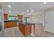 Spacious kitchen featuring a center island, modern appliances, and seamless flow into the living area at 1320 Corte Nueva, Winter Springs, FL 32708