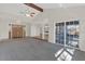 Open-concept living room boasts high ceilings, exposed beam, and seamless flow into the kitchen at 1320 Corte Nueva, Winter Springs, FL 32708