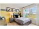Cozy bedroom featuring a comfortable bed, neutral carpet, and natural lighting from the window at 1344 Hanoverian Dr, Lake Alfred, FL 33850