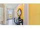 Bright hallway featuring neutral tile flooring, natural lighting, and decorative art at 1344 Hanoverian Dr, Lake Alfred, FL 33850