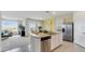 Kitchen featuring an island with granite countertops, stainless steel appliances, and a cozy seating area at 1344 Hanoverian Dr, Lake Alfred, FL 33850