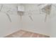 Neutral carpeted walk-in closet with plenty of shelving space at 1344 Hanoverian Dr, Lake Alfred, FL 33850