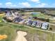 An aerial view of luxury homes nestled alongside a lush green golf course with a serene lake in the background at 16112 Vetta Dr, Montverde, FL 34756