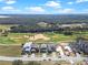 A high angle view of a neighborhood next to a golf course with sand traps and a body of water at 16112 Vetta Dr, Montverde, FL 34756