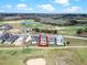 An aerial view showing the property surrounded by a golf course and lake, outlined in red for emphasis at 16112 Vetta Dr, Montverde, FL 34756