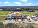 Aerial view of home outlined in red showcasing its location near a lush golf course and wooded area at 16112 Vetta Dr, Montverde, FL 34756