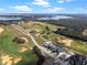 A scenic aerial view showcases a golf course community with stunning lake views and lush natural landscapes at 16112 Vetta Dr, Montverde, FL 34756