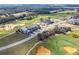 An aerial view showcasing luxury homes next to a golf course with lush greenery and mature trees at 16112 Vetta Dr, Montverde, FL 34756