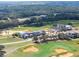 An aerial view of luxury homes near a beautiful golf course with lush green fairways and wooded areas at 16112 Vetta Dr, Montverde, FL 34756