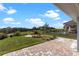 Well-manicured backyard features a brick paver patio, lush lawn, and privacy landscaping at 16112 Vetta Dr, Montverde, FL 34756