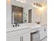 This bathroom features a dual sink vanity with modern fixtures and a spacious glass shower in the background at 16112 Vetta Dr, Montverde, FL 34756