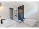A luxurious primary bathroom features a glass enclosed shower, soaking tub, and dual sink vanity at 16112 Vetta Dr, Montverde, FL 34756