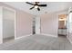 Neutral colored bedroom with carpet, ceiling fan, and well lit ensuite bathroom at 16112 Vetta Dr, Montverde, FL 34756