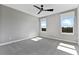 Spacious bedroom with neutral walls, carpet flooring, and natural light from two windows at 16112 Vetta Dr, Montverde, FL 34756