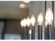 A modern chandelier with candelabra bulbs is a stylish focal point for the room at 16112 Vetta Dr, Montverde, FL 34756