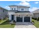 Beautiful two-story home featuring a stone facade, a two-car garage, and professionally landscaped front yard at 16112 Vetta Dr, Montverde, FL 34756