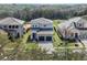 Exterior shot showing a well-manicured home with stone accents, a dark roof, and a neatly paved driveway at 16112 Vetta Dr, Montverde, FL 34756