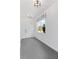 Hallway with tiled floors, natural light from a window, and neutral walls at 16112 Vetta Dr, Montverde, FL 34756