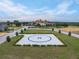 Community heliport features an 'H' landing pad, manicured lawn, and nearby luxury home at 16112 Vetta Dr, Montverde, FL 34756