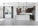 Modern kitchen with stainless steel appliances, dark cabinetry, a stylish tile backsplash, and an island at 16112 Vetta Dr, Montverde, FL 34756