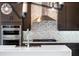 A gourmet kitchen boasts stainless steel appliances, a modern range hood and sleek countertops at 16112 Vetta Dr, Montverde, FL 34756