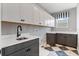 Well-organized laundry room with ample cabinet space, stylish flooring, and modern fixtures at 16112 Vetta Dr, Montverde, FL 34756