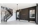 Interior view of an open living space featuring tile floors, modern chandelier, staircase, and neutral color palette at 16112 Vetta Dr, Montverde, FL 34756
