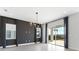 Open living space featuring a decorative chandelier, grey-toned accent wall, tile floors, and sliding glass doors to the yard at 16112 Vetta Dr, Montverde, FL 34756