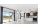 Bright and airy living space featuring an open floor plan, tile floors, and a modern kitchen with stainless steel appliances at 16112 Vetta Dr, Montverde, FL 34756