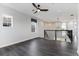 Inviting loft featuring dark wood-look flooring, a window with a view, a modern light fixture, and white walls at 16112 Vetta Dr, Montverde, FL 34756