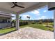 Beautiful outdoor living space with covered patio, brick pavers, and manicured landscaping at 16112 Vetta Dr, Montverde, FL 34756