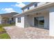 Covered patio featuring a brick paver floor and sliding glass doors at 16112 Vetta Dr, Montverde, FL 34756