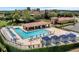 Community pool area with lounge chairs, cabanas, and shaded seating in outdoor pavilion at 16112 Vetta Dr, Montverde, FL 34756